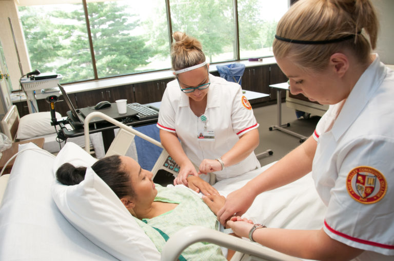 Nursing students treat a patient